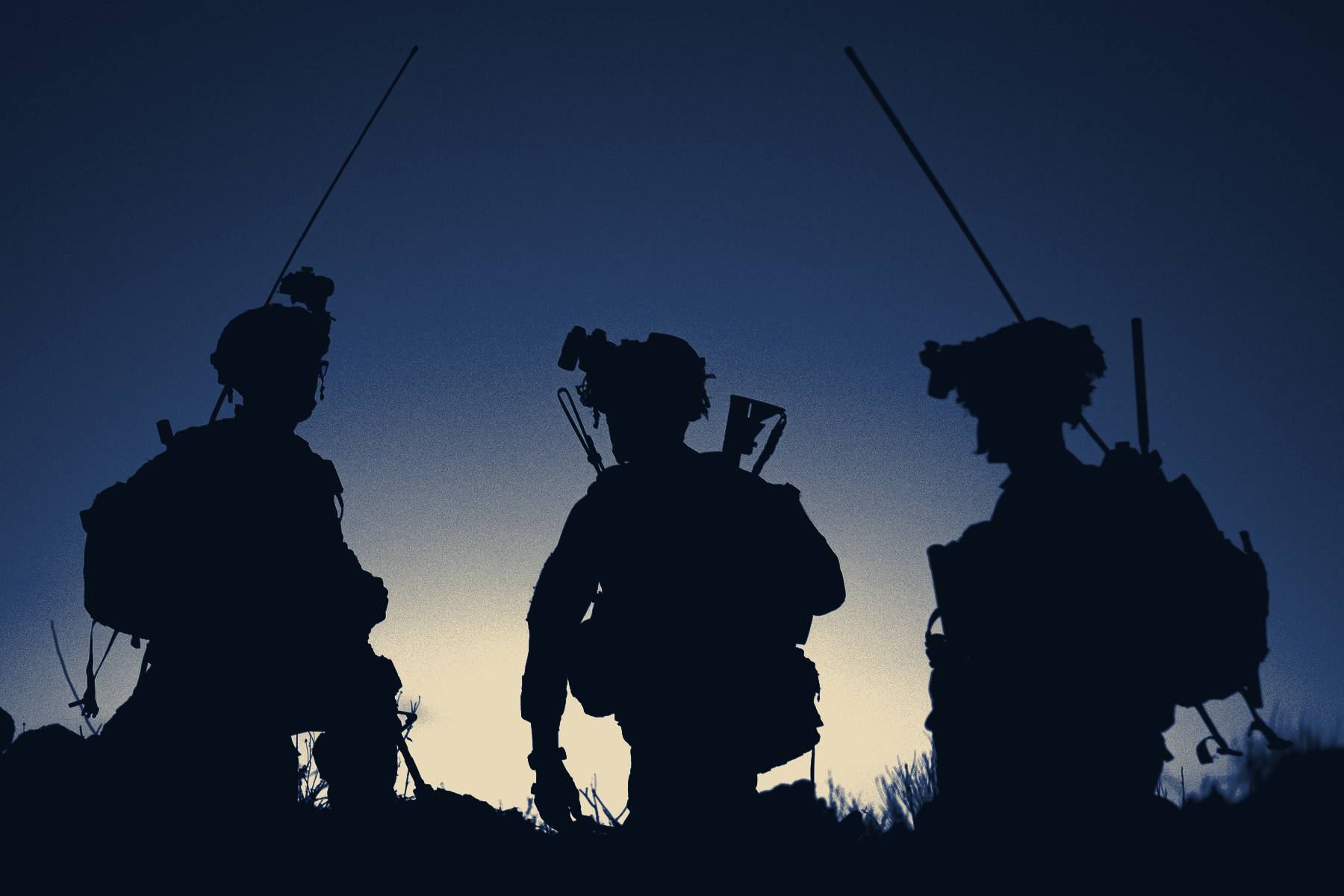 Three soldiers in silhouette at dusk, conferring