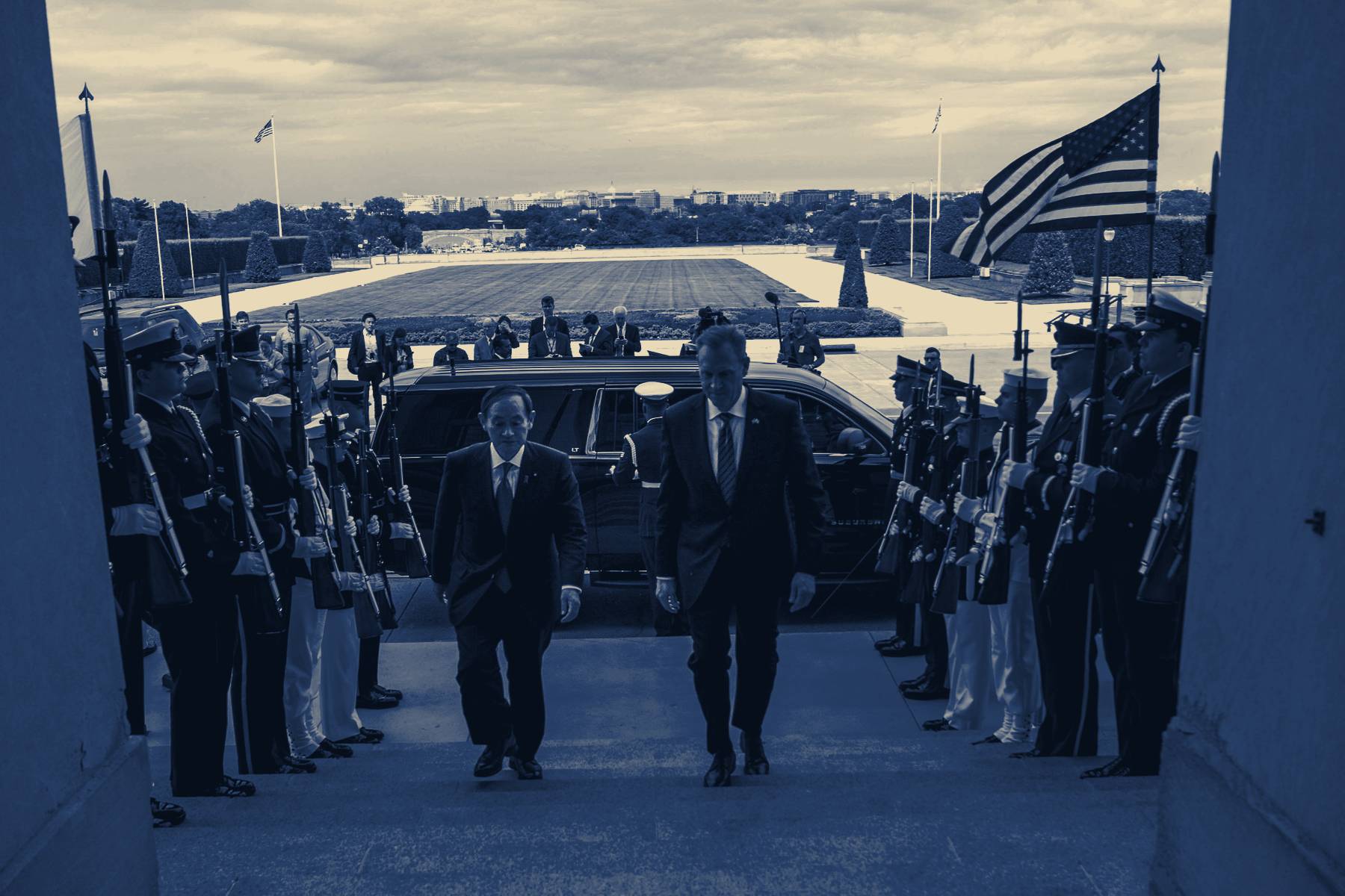 Two officials walking through an honor cordon at the Pentagon